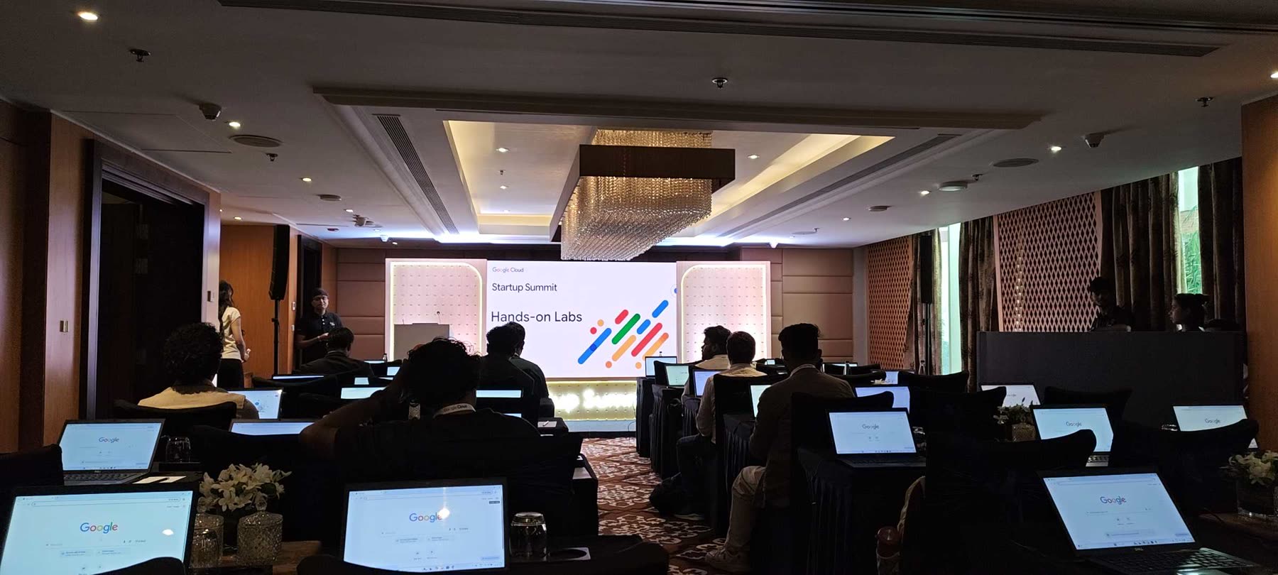 Attendees at laptops in the Startup Summit Hands-on Labs room, with the session title on the screen